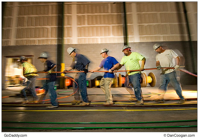 GoDaddy.com workers hauling copper cable