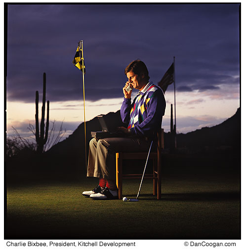 Charlie Bixbee, President, Kitchell Development, sitting on a golf green, talking on a cell phone