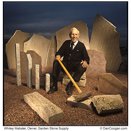 Whitey Webster, Owner, Garden Stone Supply sits amungst flagstone