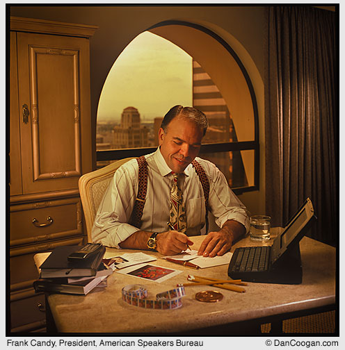 Frank Candy, President, American Speakers Bureau Inc., writing at a desk